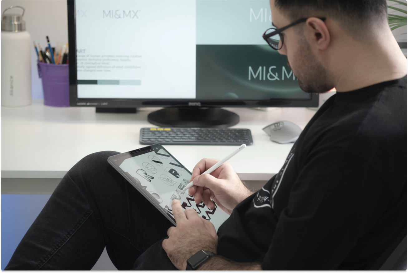 Man sitting and drawing on writing tablet